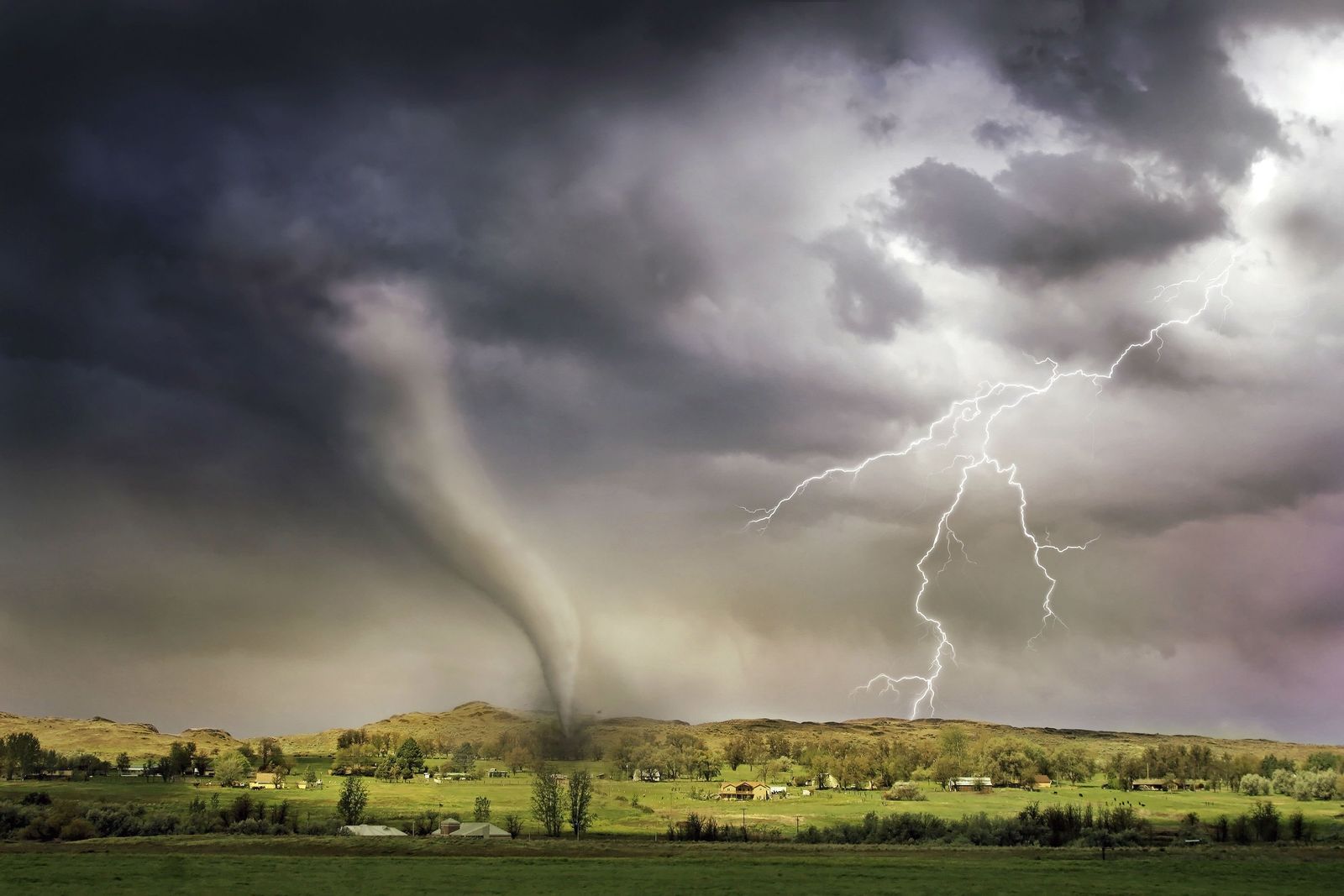 Tornado and lightning over a rural High Plains landscape